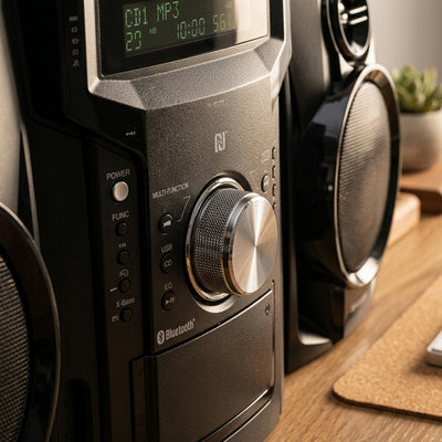 Macro detail of the Sharp CD-BH950 stereo featuring a textured volume knob and NFC pairing sensor.
