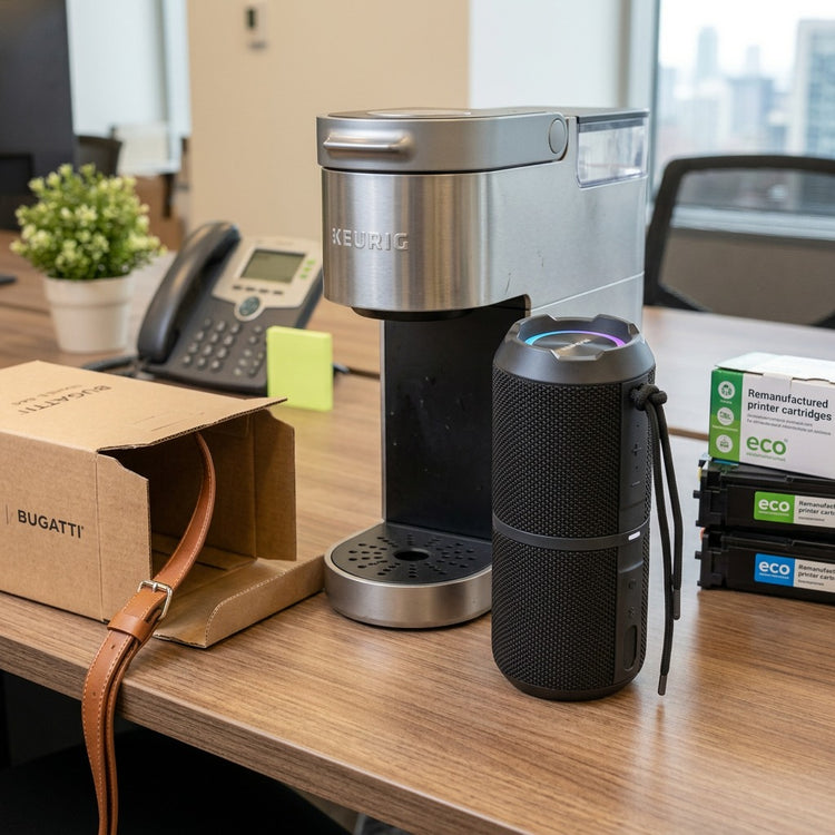 Sharp GX-BT290-BK portable speaker on a desk next to a Keurig coffee maker for size reference.