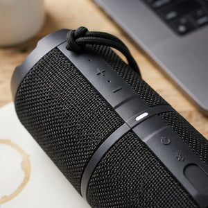 Macro detail of the Sharp GX-BT290-BK speaker controls, durable mesh, and black carry strap.