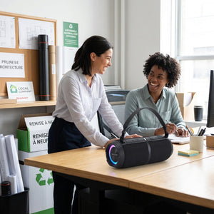 Sharp GX-BT390 rugged black speaker used by team members in a bright, eco-conscious office studio.
