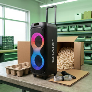 Sharp PS-935 party speaker unboxing with protective shipping materials, microphone, and cables.